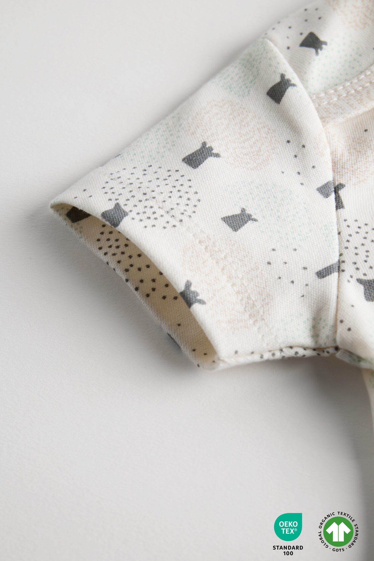Folded fabric with gray rabbit pattern on a white background
