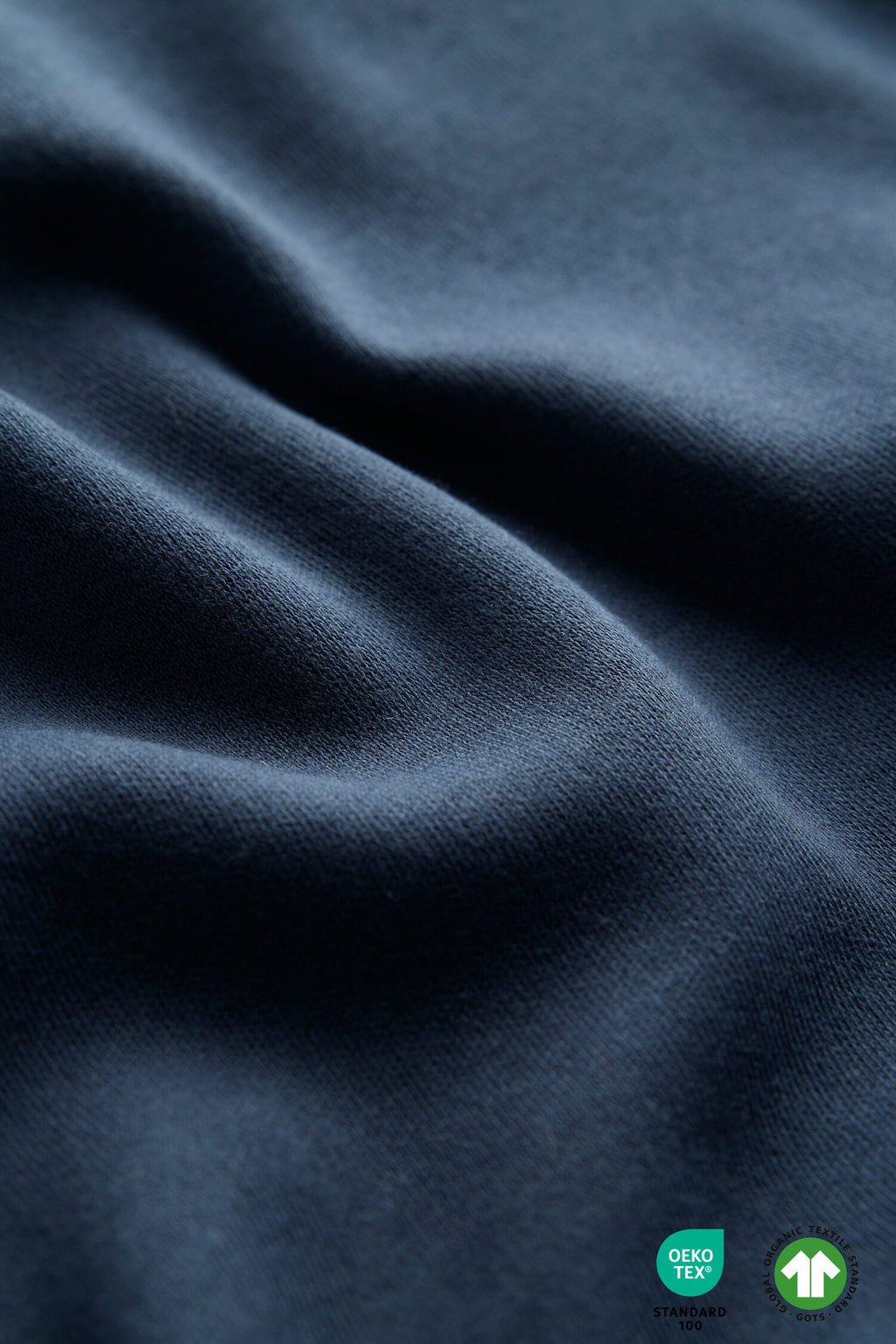 Close-up of dark blue fabric with a GORE-TEX and fleece label.