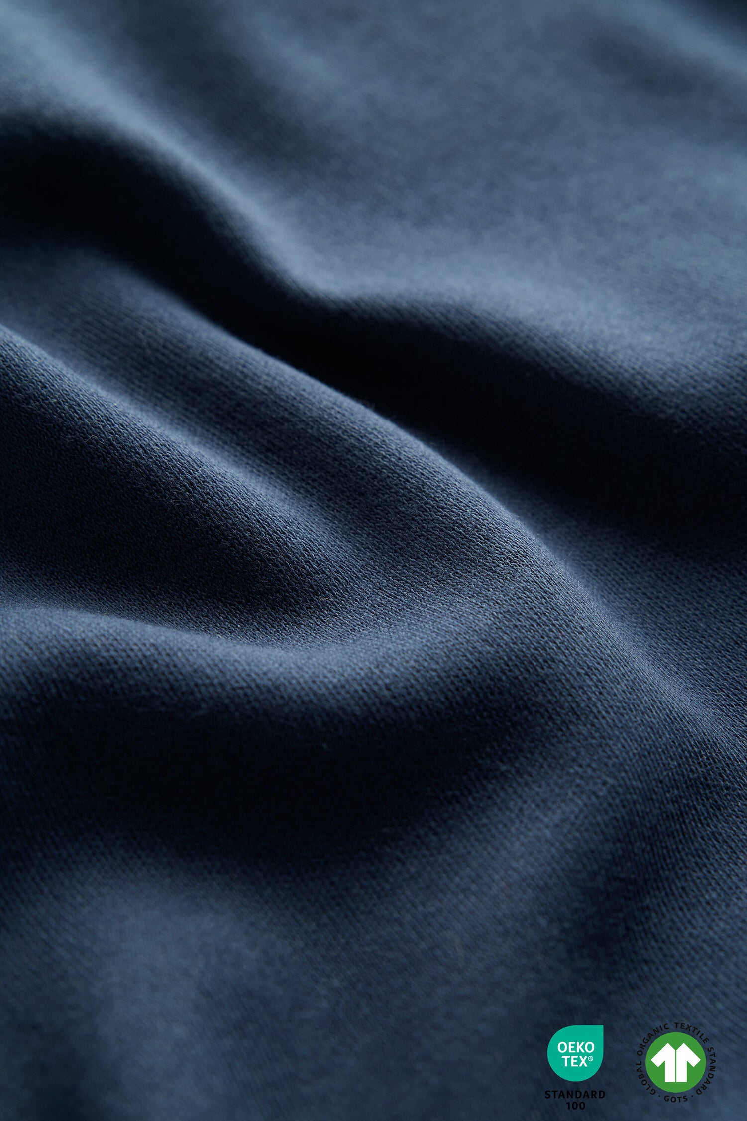 Close-up of dark blue fabric with a GORE-TEX and fleece label.
