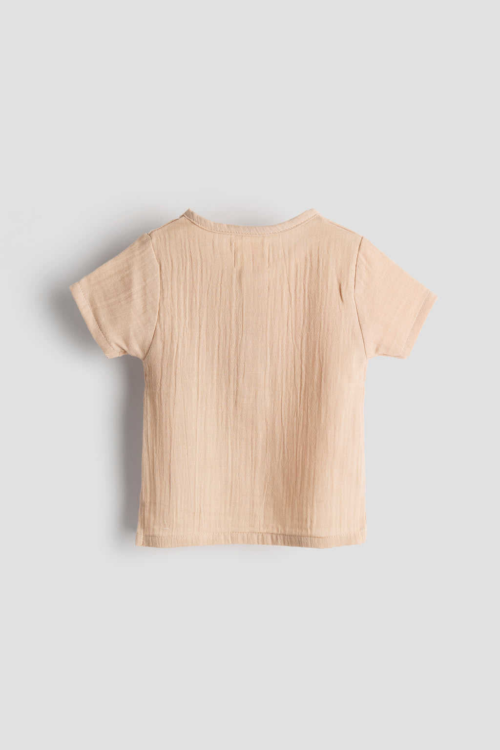Beige t-shirt on a light gray background