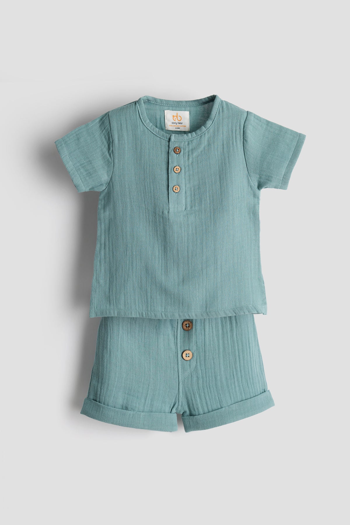 Light blue children's shirt and shorts set on a light gray background