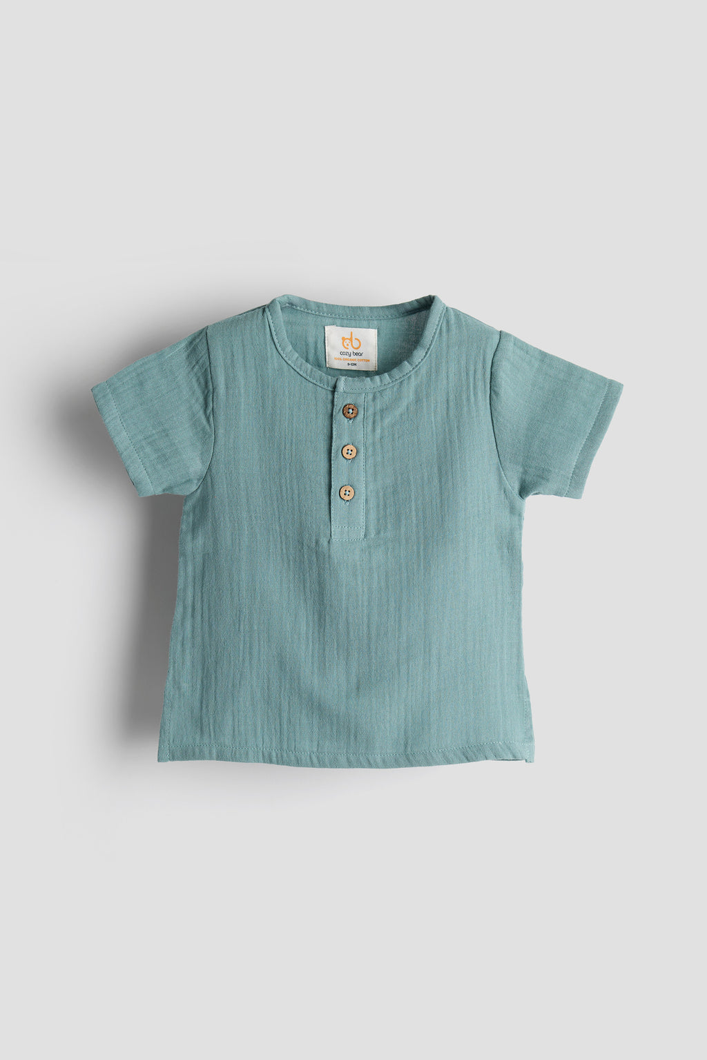 Light blue baby shirt with buttons on a white background