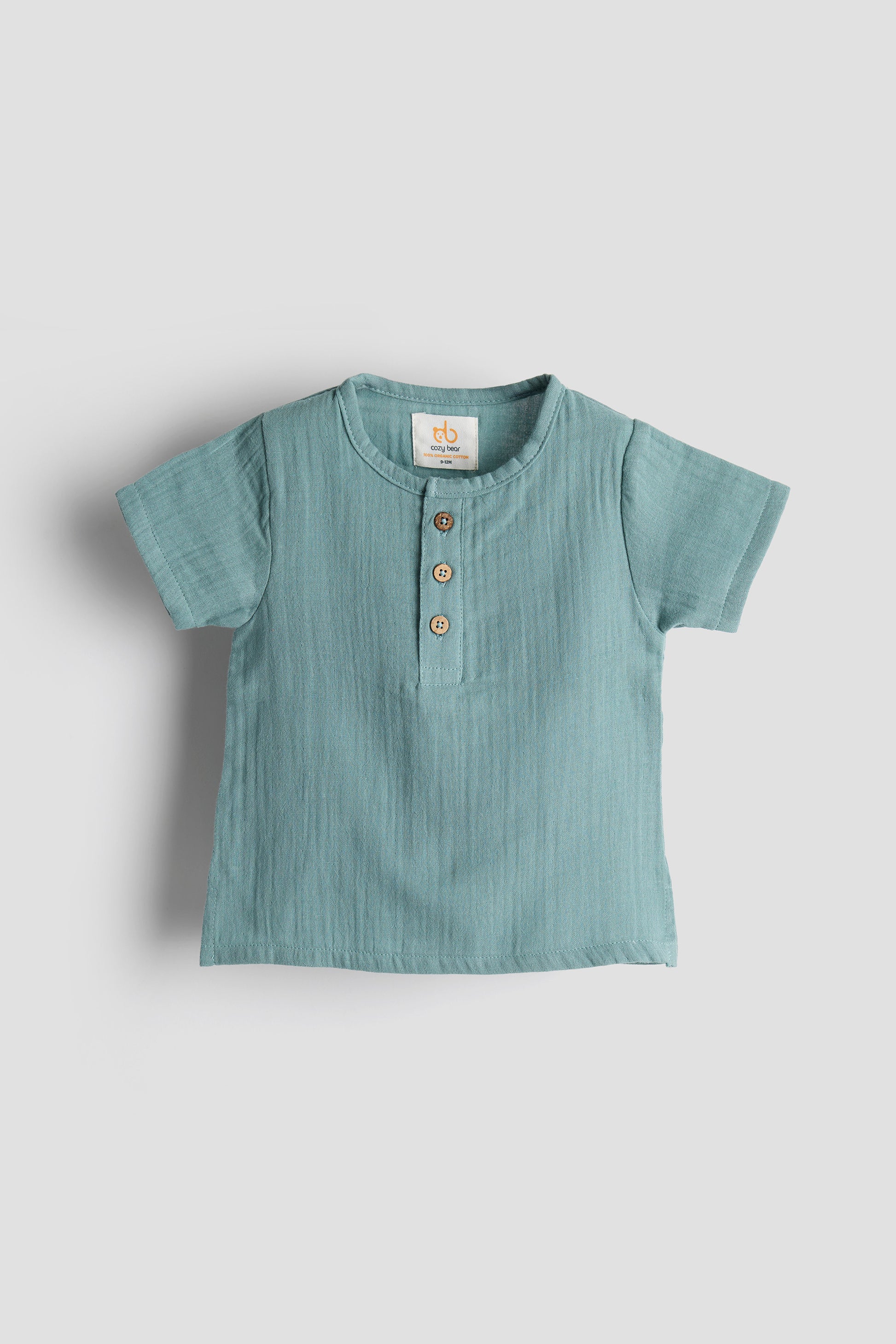 Light blue baby shirt with buttons on a white background