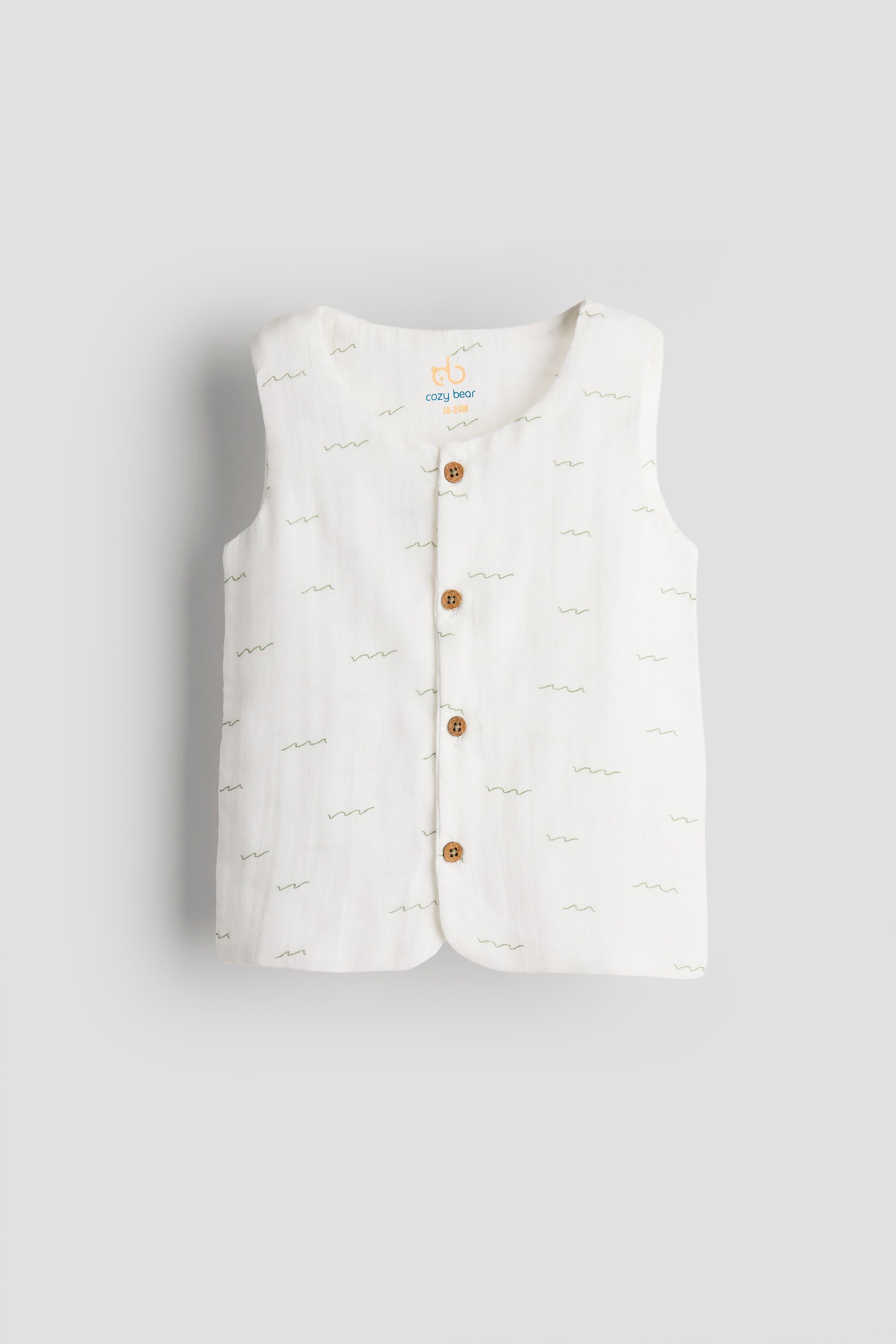 White quilted vest with brown buttons on a light gray background