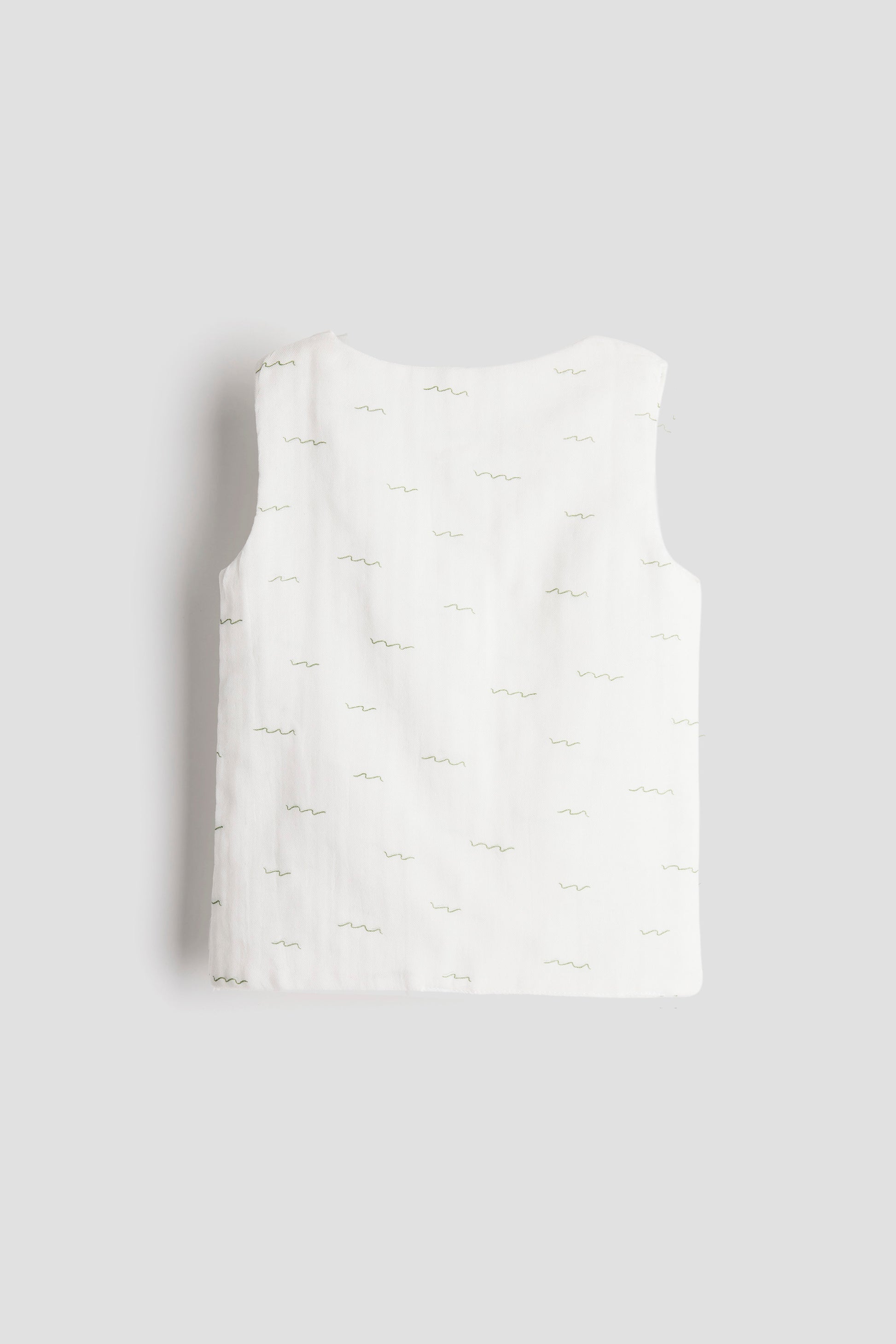 White sleeveless top on a light gray background