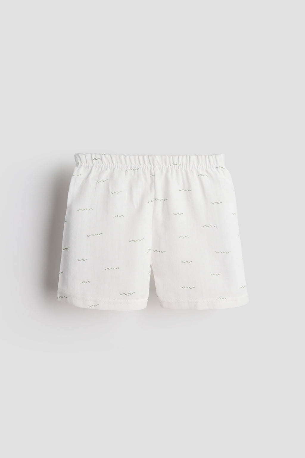 White shorts with a subtle pattern on a light gray background
