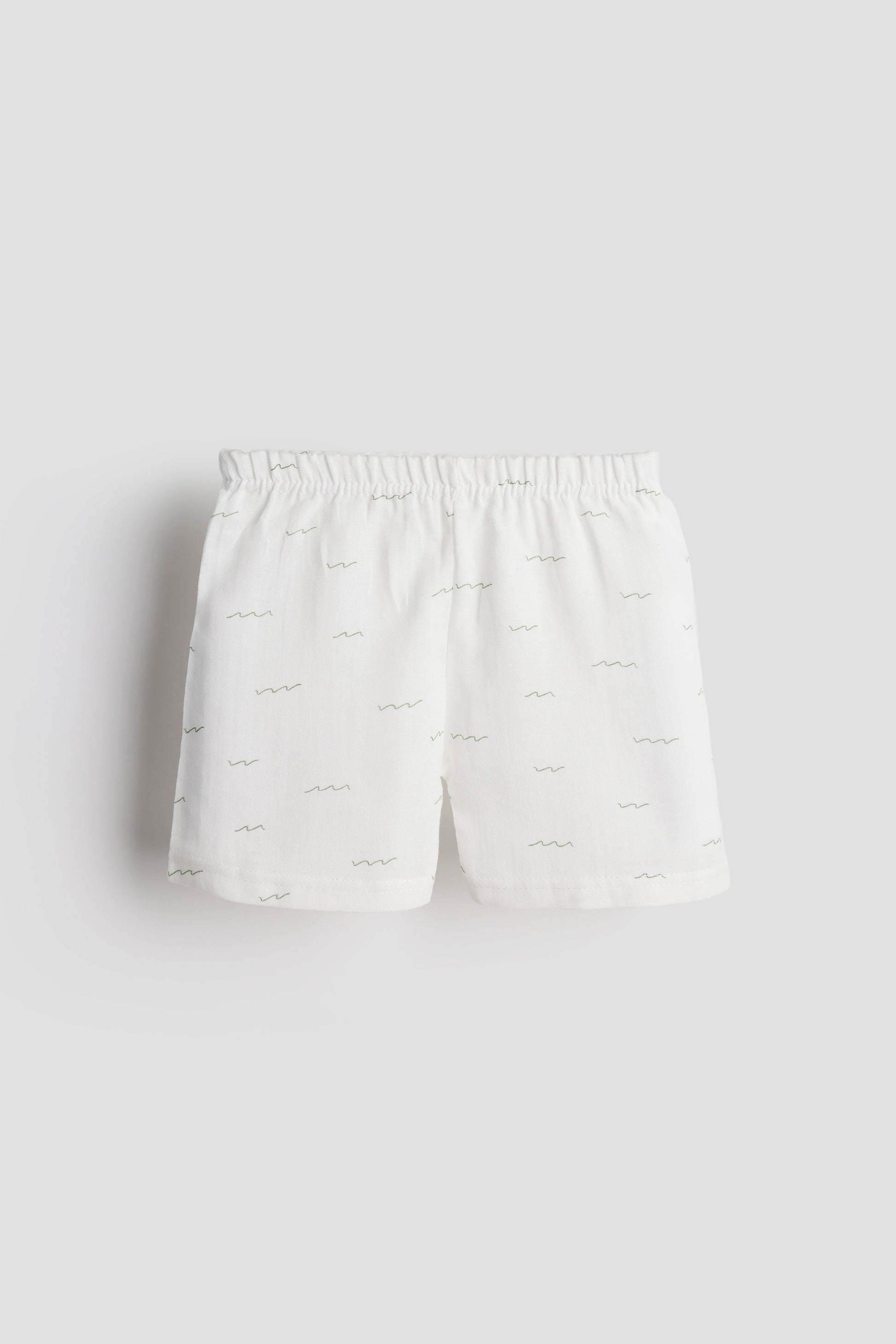 White shorts with a subtle pattern on a light gray background