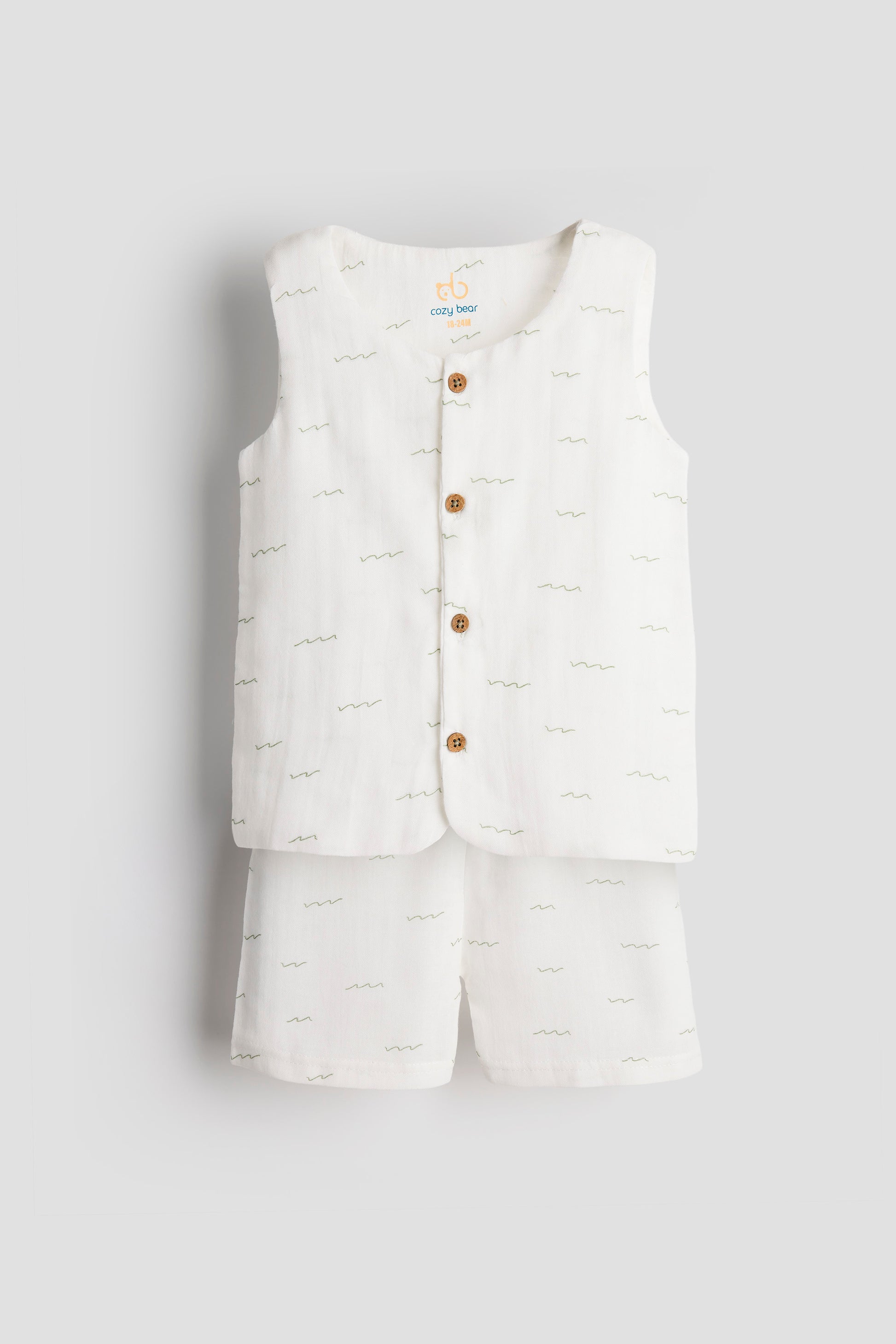 White puffer vest with brown buttons and matching shorts on a light gray background