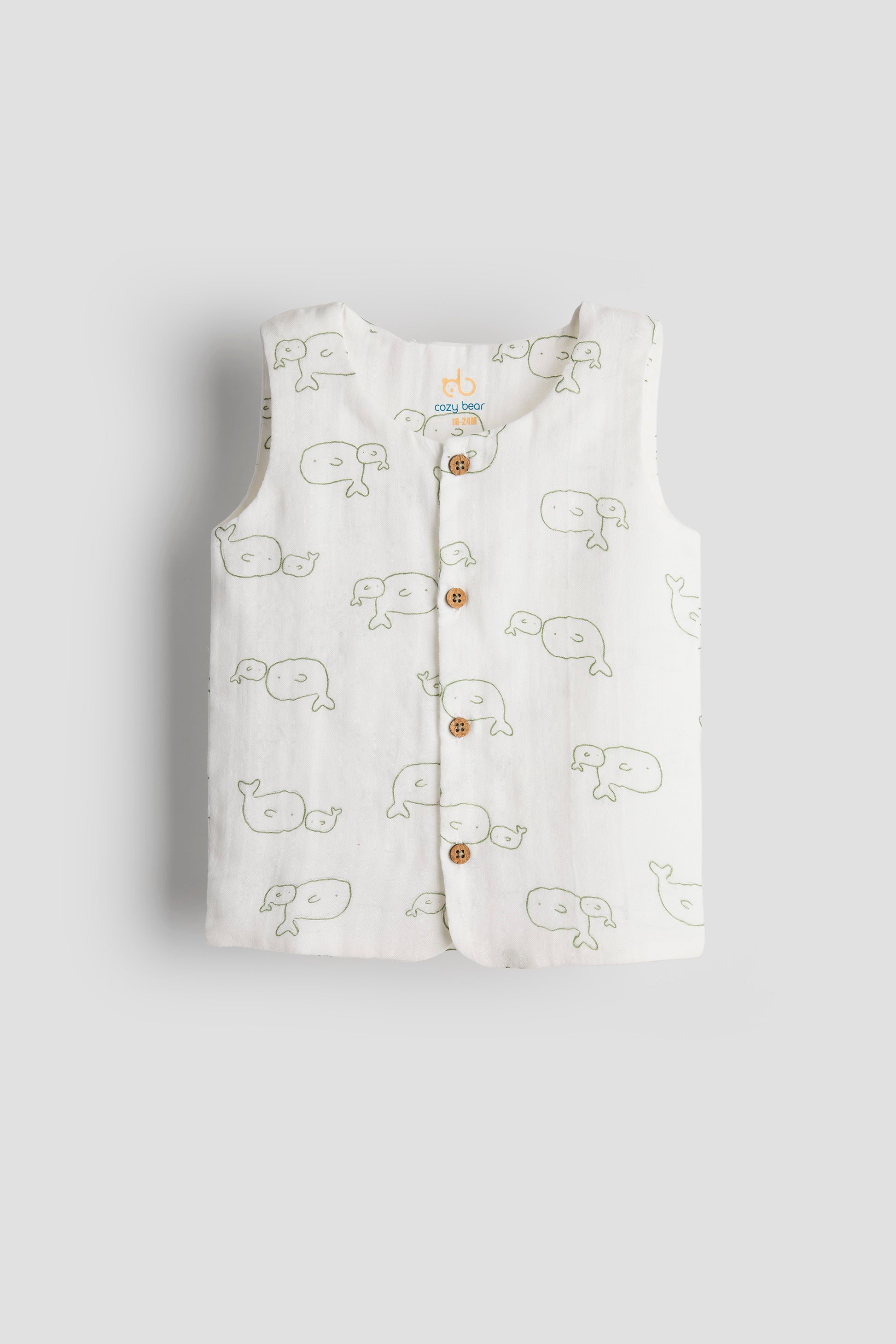 White sleeveless shirt with whale pattern on a light gray background