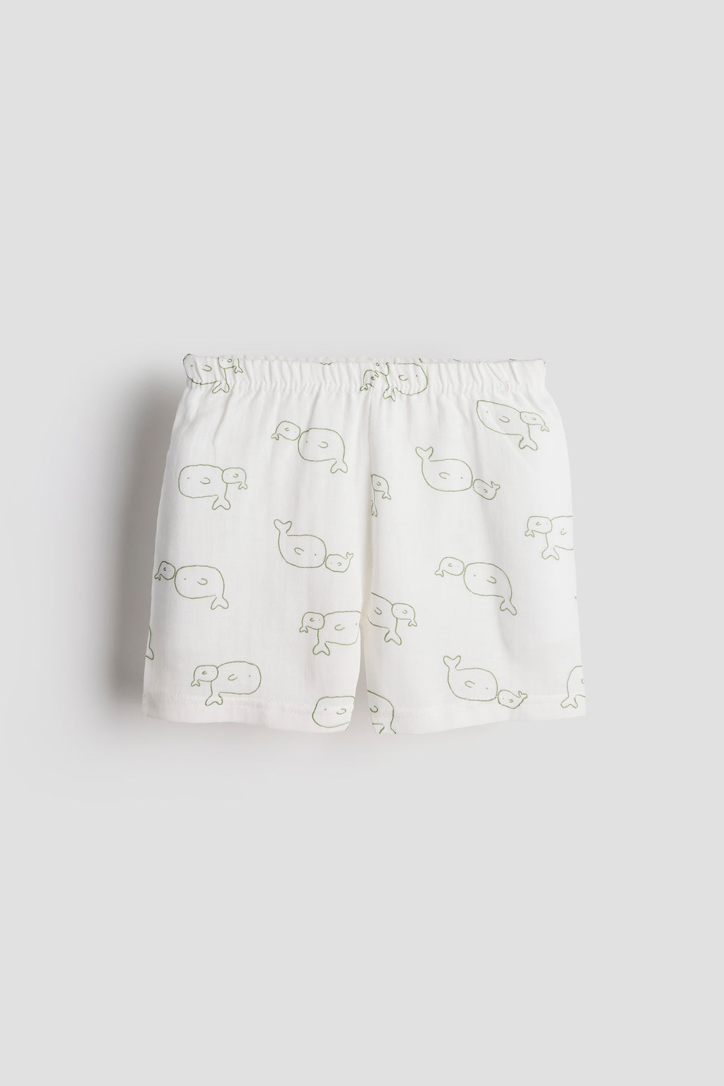 White shorts with whale pattern on a light gray background