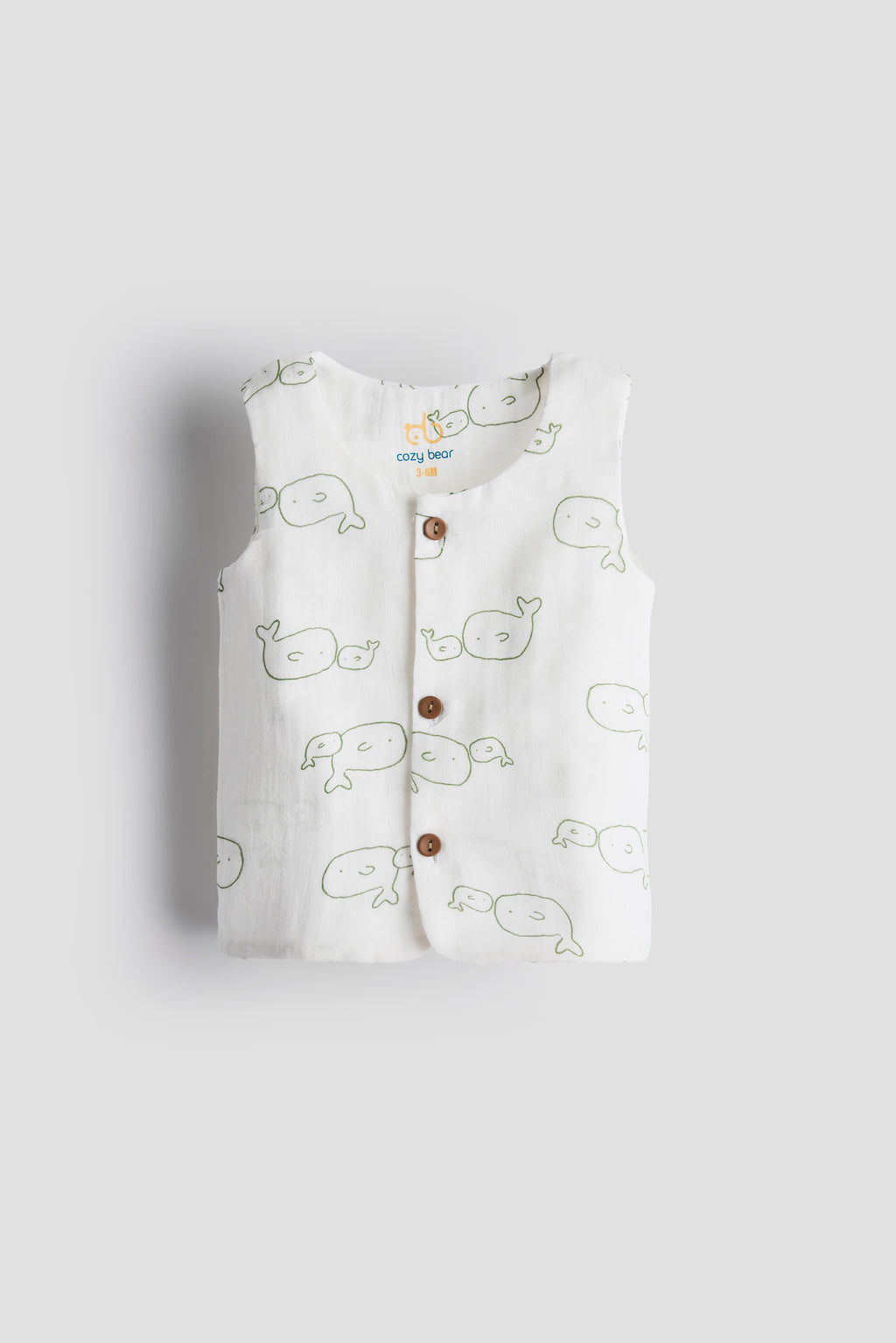 Baby vest with whale pattern on a light gray background