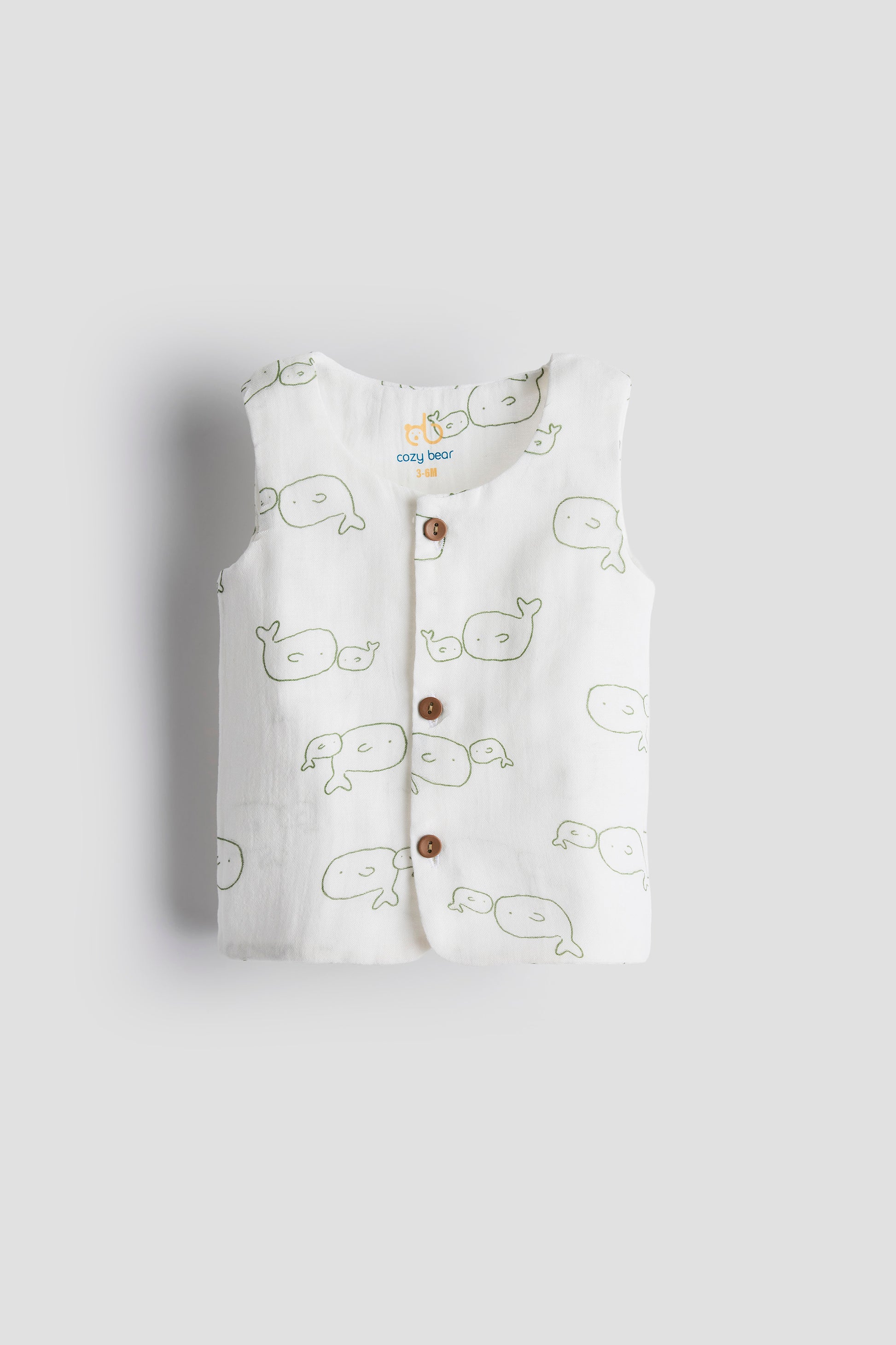 Baby vest with whale pattern on a light gray background